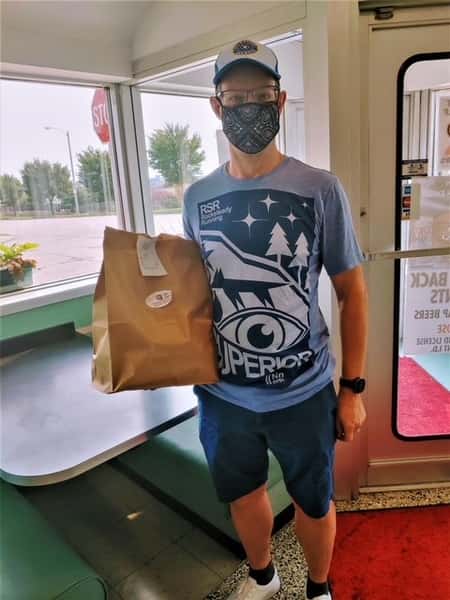 Customer with mask picking up order