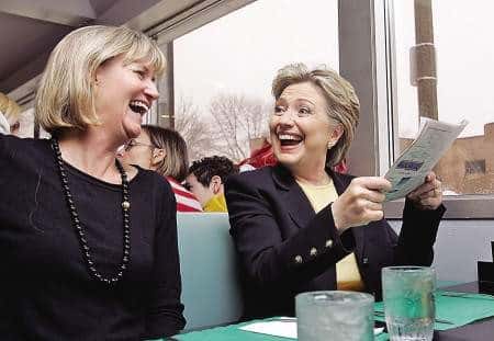 Hillary Clinton smiling with guests