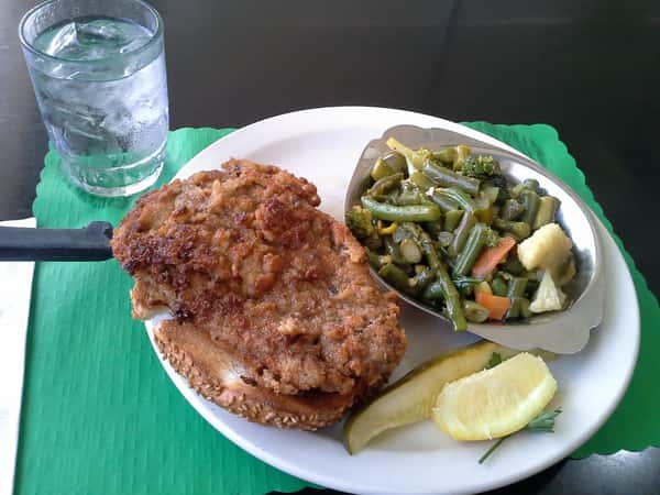 fried steak with side of greens