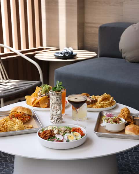 A beautifully arranged table with an assortment of delicious food, including snacks and vibrant drinks