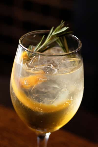 citrus cocktail garnished with rosemary