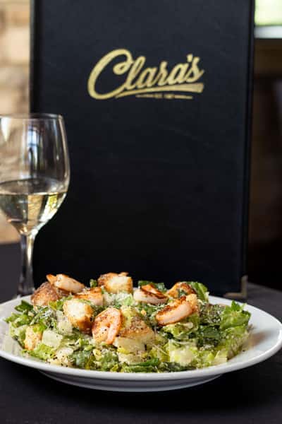 server holding salad with shrimp