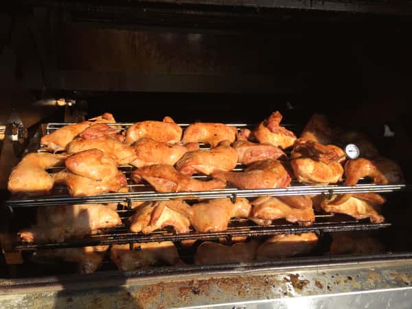 large grill with roasted chickens