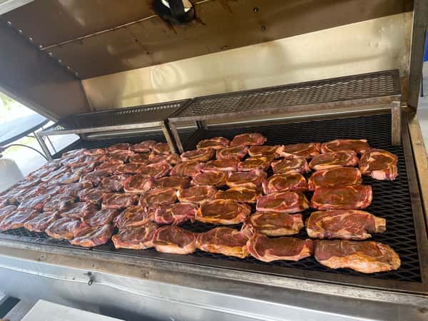 large cooker full of smoked meat