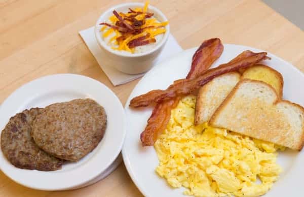 plates with eggs, toast, bacon and sausage