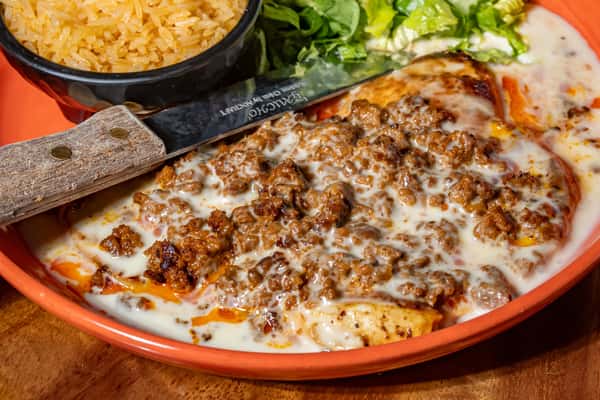Grilled chicken topped with melted queso and seasoned ground beef, served with Mexican rice and fresh lettuce.