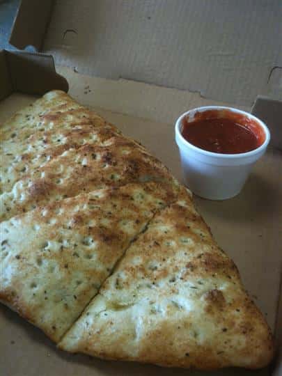 A stromboli with tomato sauce on the side