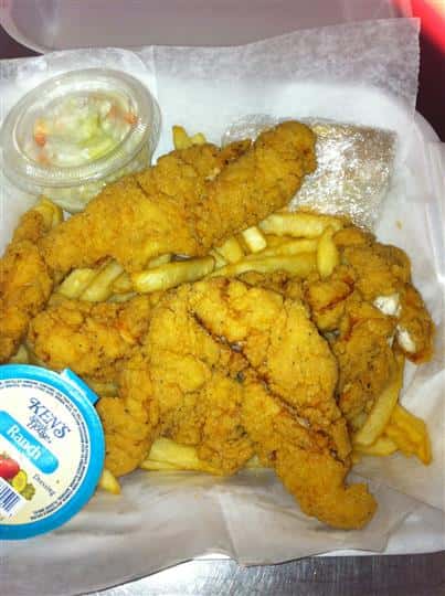 Chciken tenders with french fries and ranch dipping sauce on the side