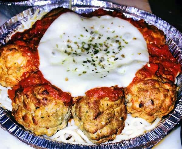 Meatballs with tomato sauce and mozzarella cheese melted on top