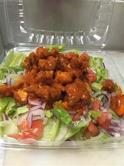 Salad with buffalo chicken on top