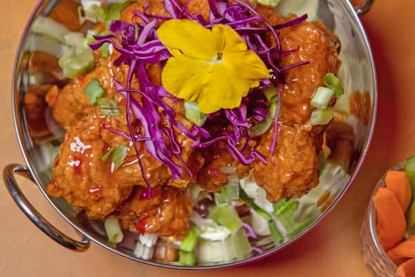 Sweet chicken tenders topped with purple cabbage garnish