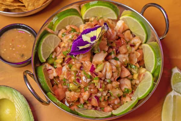 Fresh ceviche in a bowl topped with diced vegetables
