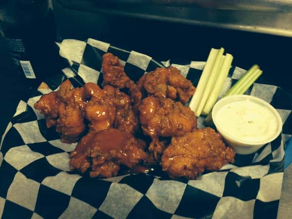 buffalo wings in a basket with dipping sauce