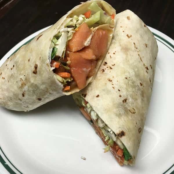 chicken wrap with lettuce and tomatoes on a plate