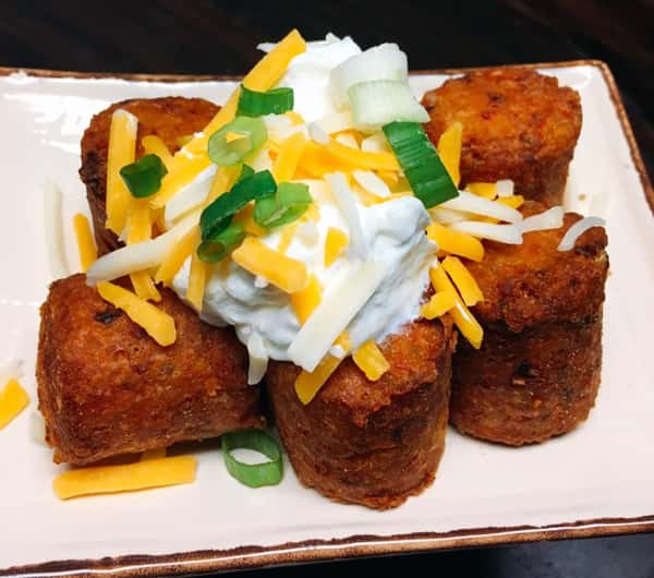fried egg rolls topped with sour cream and onions