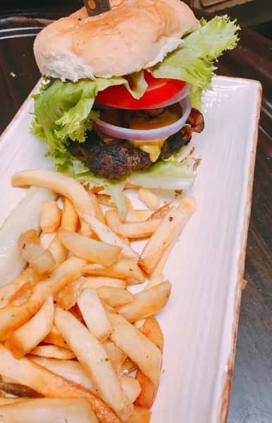 cheeseburger with onions, tomatoes and a side of fries