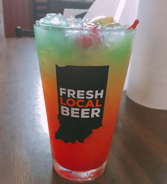 mixed drink in a glass that says "fresh local beer"