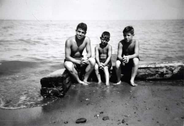 old black and white photo of Comella's family members on the beach
