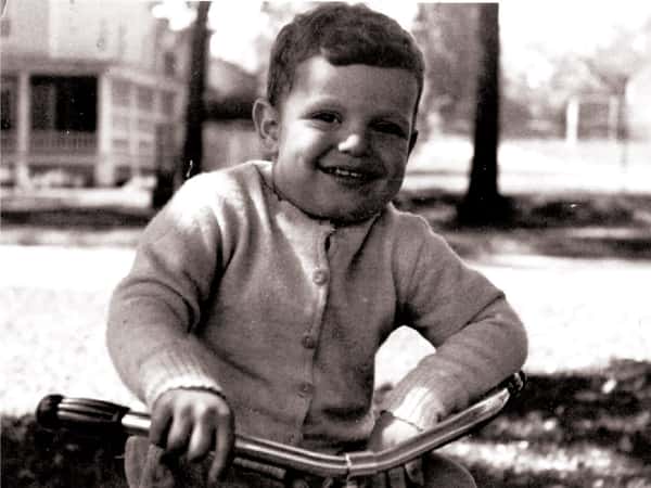 old black and white photo of Comella's family member a boy on a bike