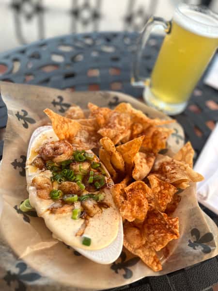 Perfectly grilled shrimp on top of hot queso and served with house fried chips.