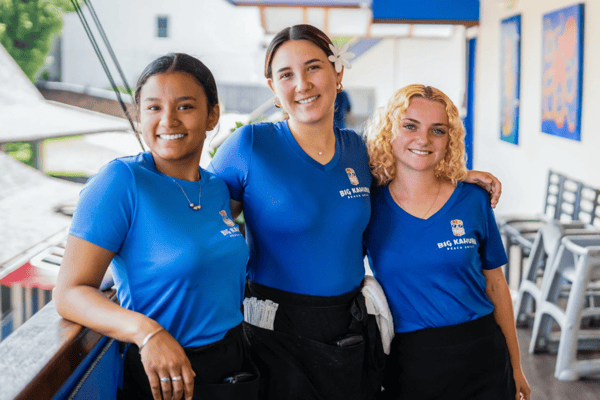 Team members standing close to each other smiling