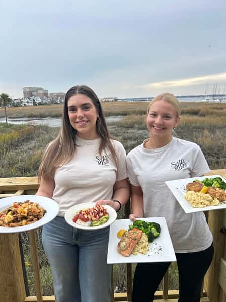 Girls with seafood meals in their hands
