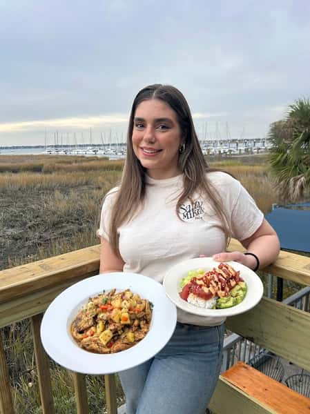 Girl with seafood meals in her hands