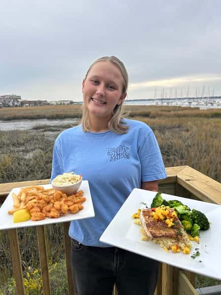 Girl with seafood meals in her hands