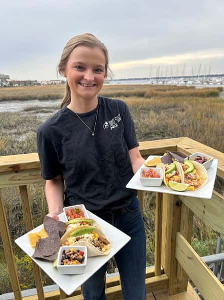 Girl with seafood meals in her hands