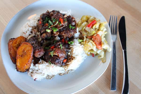 Oxtail with rice and peas, vegetables, and plantains