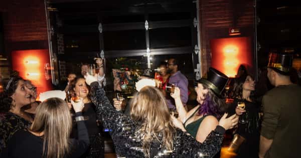 Group of people dancing and celebrating NYE