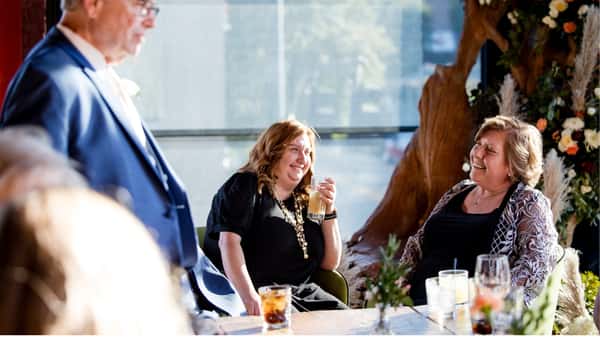Women Laughing Dining Together at Vidrio