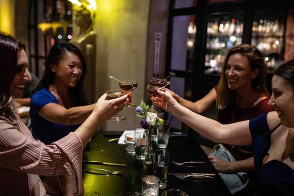 Women clinking cocktails glasses at Vidrio