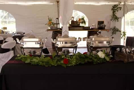 Appetizer table with three chafing dishes. 