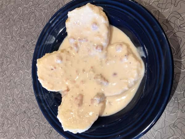 four biscuits with gravy on a plate