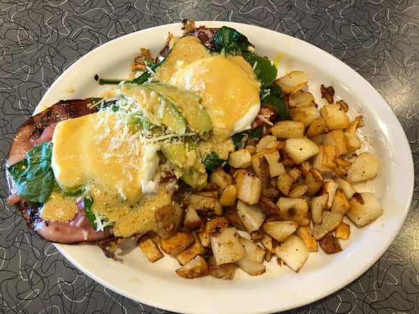 seafood omelette on a plate with a side of home fries