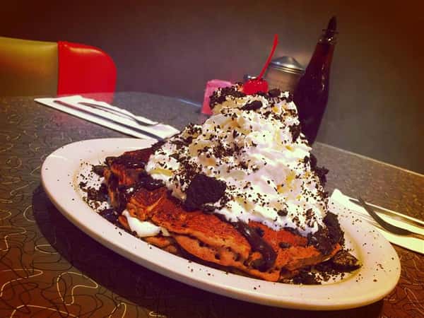 Pancakes with whipped cream and oreo crumbs