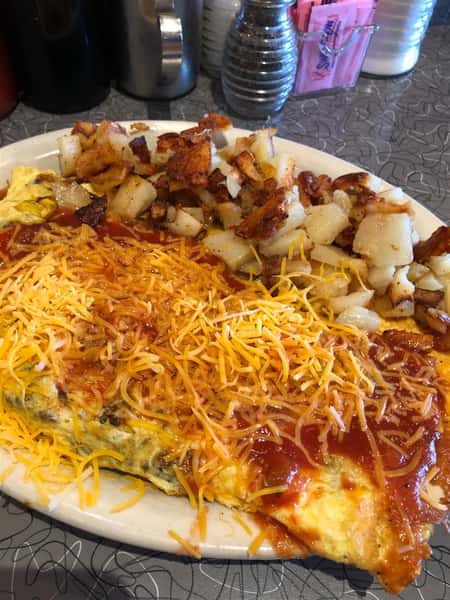 a breakfast omelette with a side of home fries