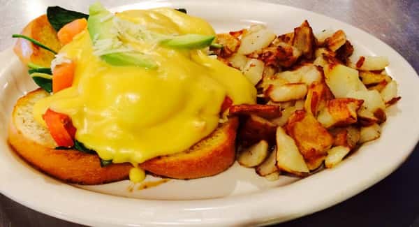 Sandwich with egg, cheese and avocado with a side of potatoes