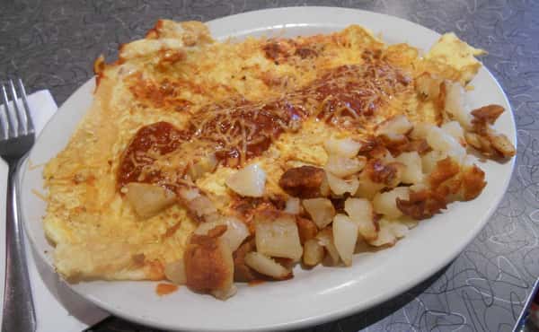 Eggs with sauce and potatoes