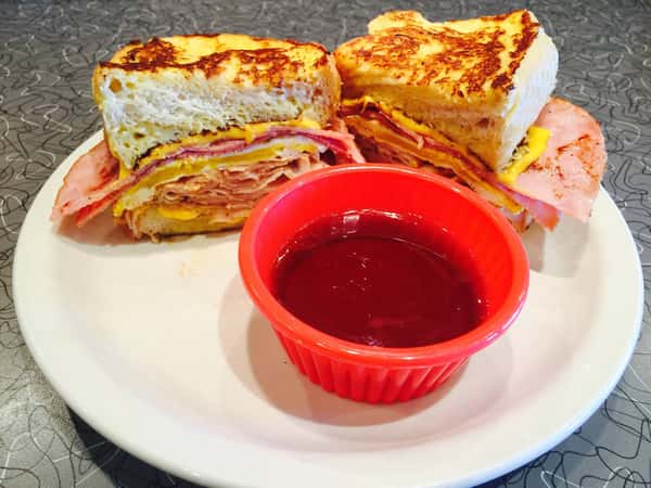 Ham sandwich with cheese and dipping sauce