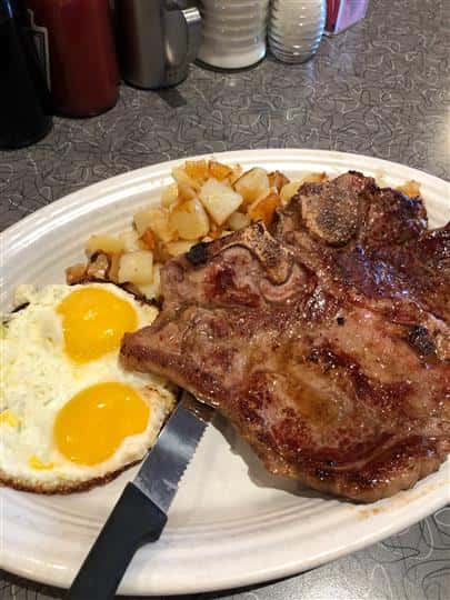 Steak and two eggs with side of potatoes