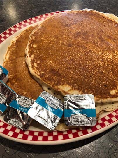 Two pancakes with side of butter
