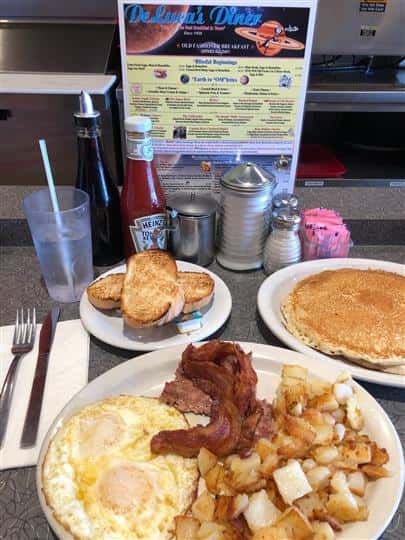 Eggs, bacon, toast, potatoes, and pancakes