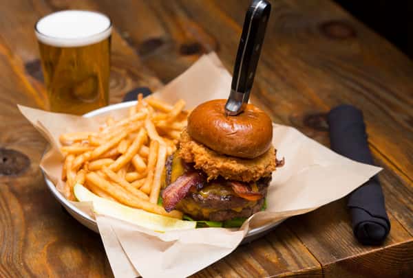 Stacked McCray's Tavern cheeseburger with melted cheese and crispy fries