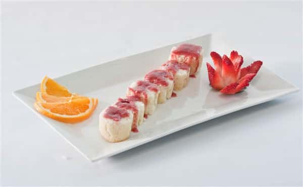 Sushi Platter containing 6 rolls complimented with 2 orange slices and a elegantly cut strawberry