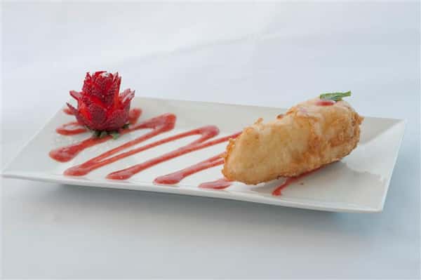 Tempura served with an elegantly cut strawberry and aesthetically displayed sauce
