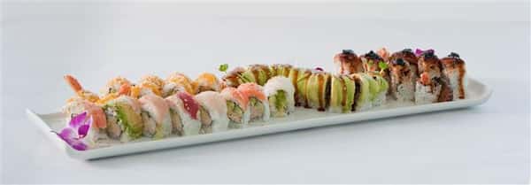 Sushi platter with a plethora of different sushi rolls served with a flower garnish