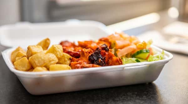 Chicken tikka pieces served with chunky chips, fresh salad and sauce.
