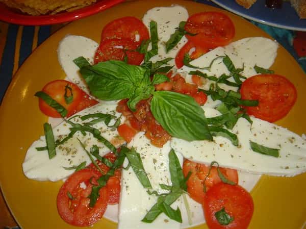 cheese topped with garnish and tomatoes
